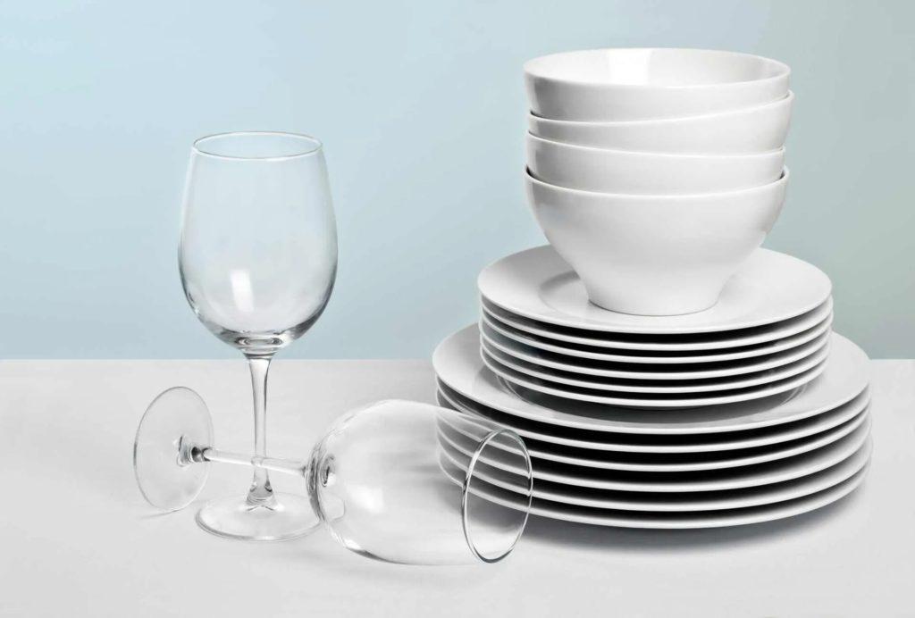 white bowl plates and two wine glasses